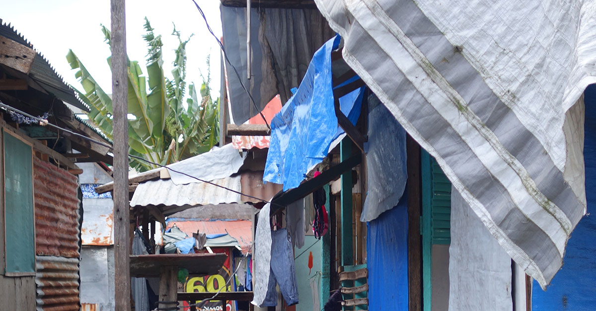 Salvaged materials on walls and roof of houses in informal settlement