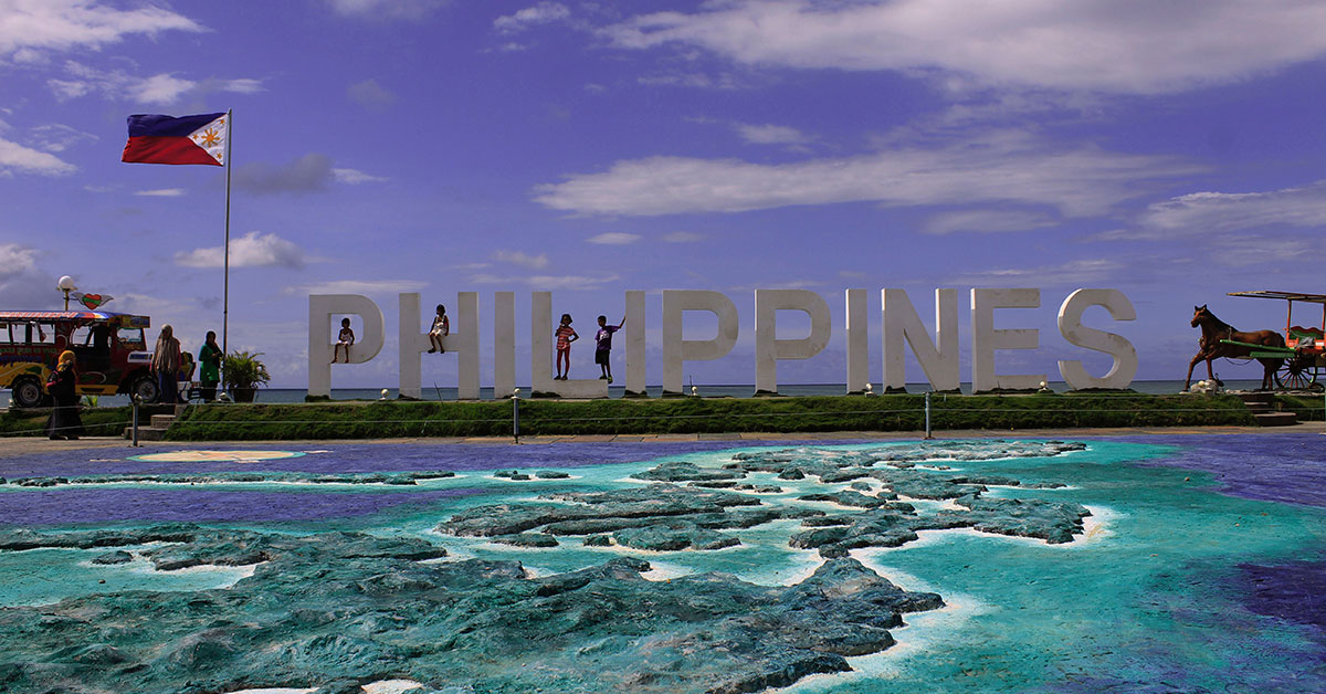 Letters spell our Philippines next to Filipino flag