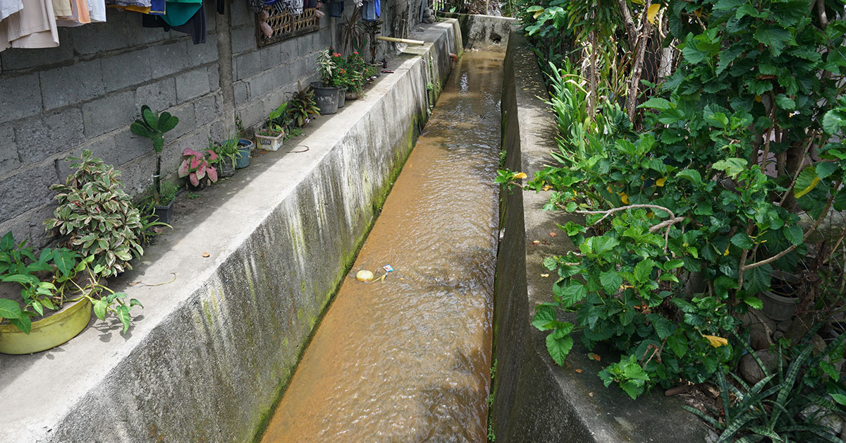 Concrete lined drain with flowing water